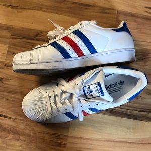 Red and blue Adidas Superstar shell toe’s